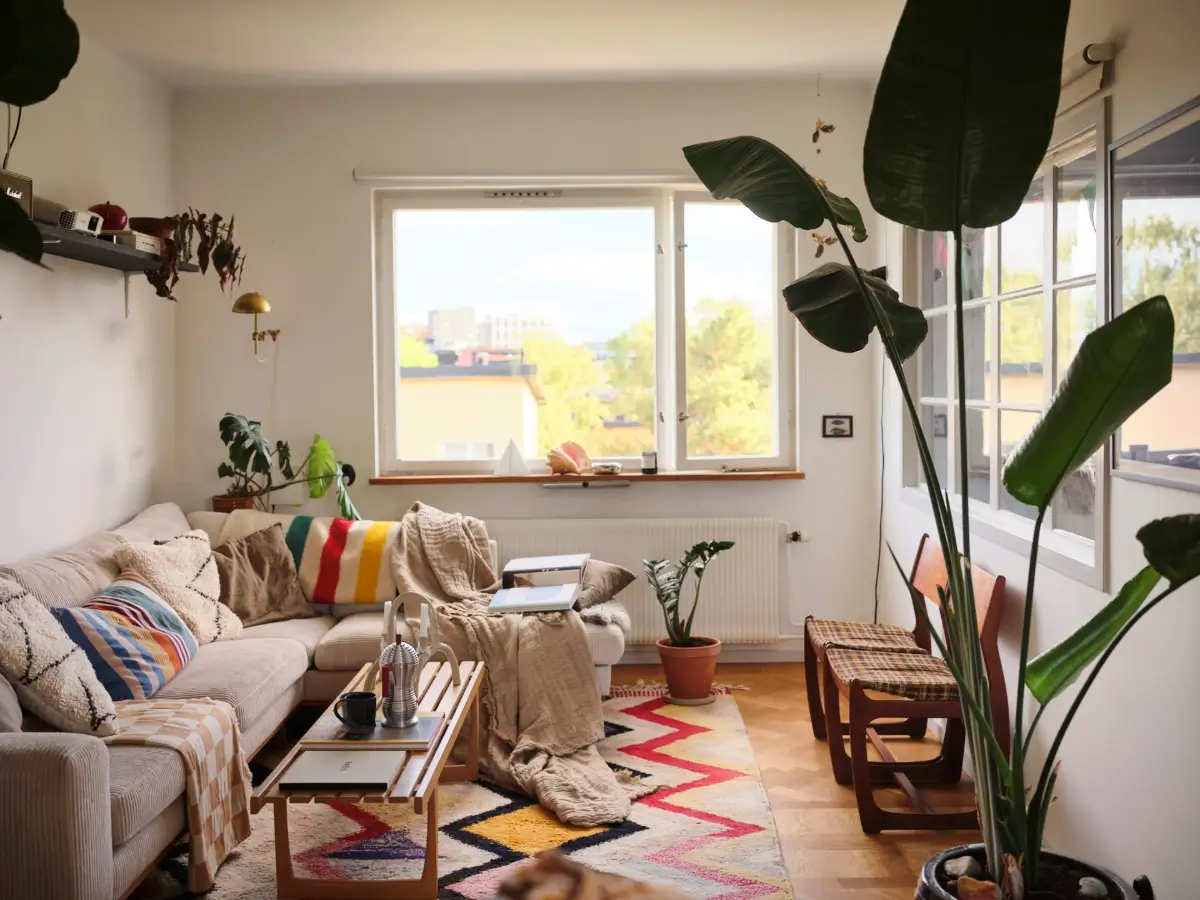 A Pink Bathroom and a Plywood Kitchen in a Stockholm Apartment 12 living room parquet floor colorful rug