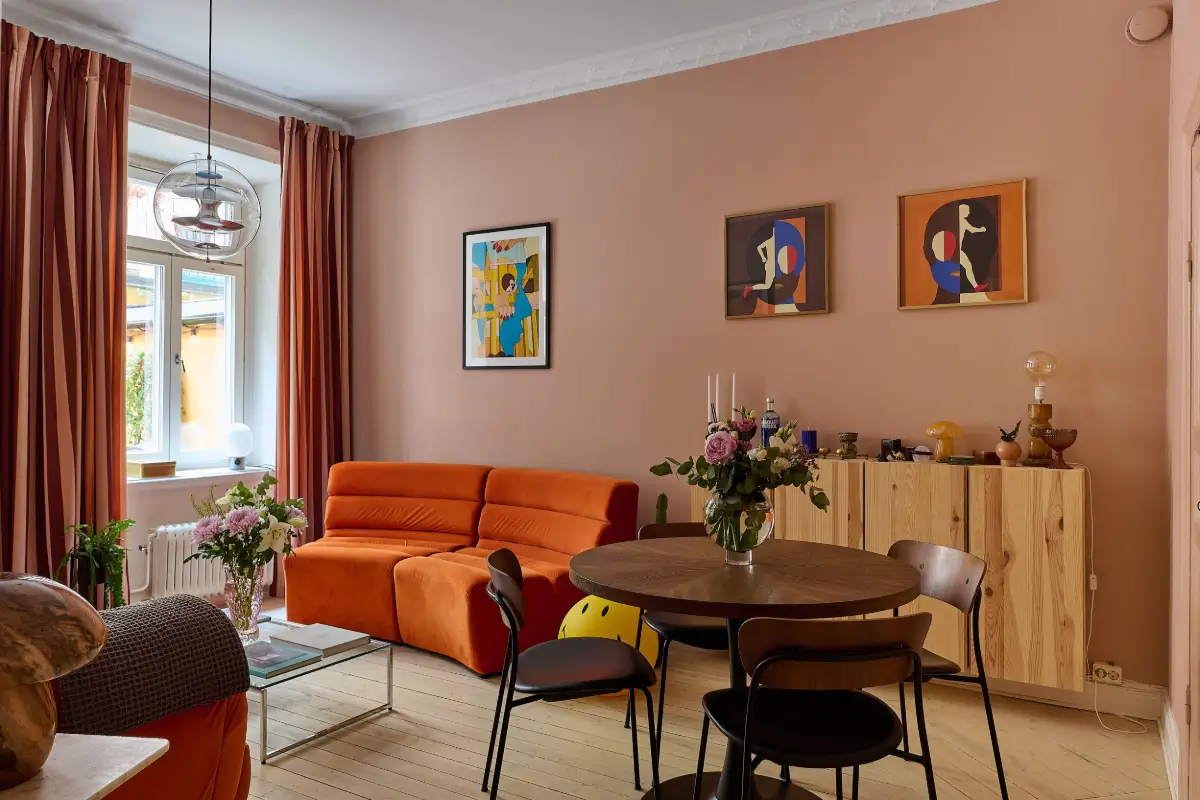 living room pink walls orange sofa
