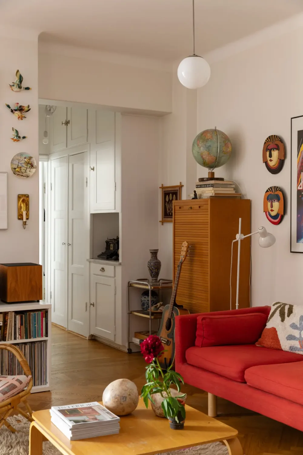 A Cozy 1920s Apartment Filled with Books, Art, and Music 15 living room view into hall