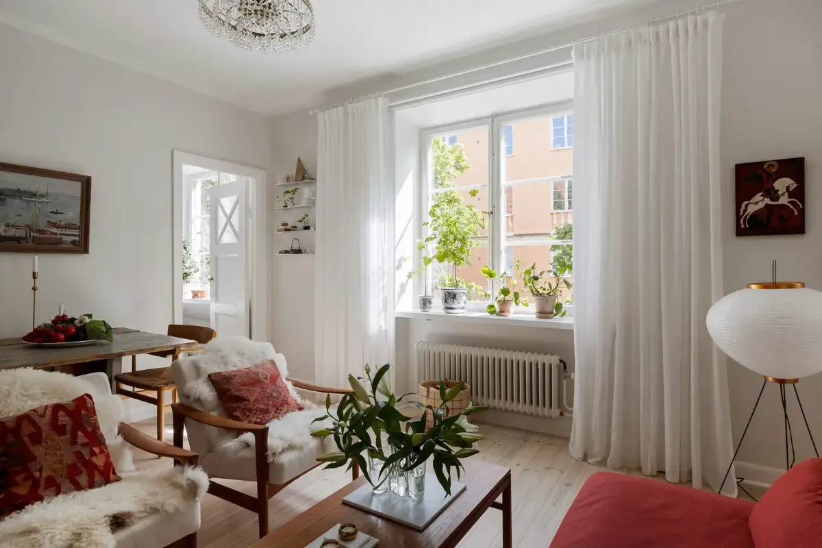 A Red Kitchen in a Small and Light Scandinavian Apartment 10 living room white walls wooden floor red sofa