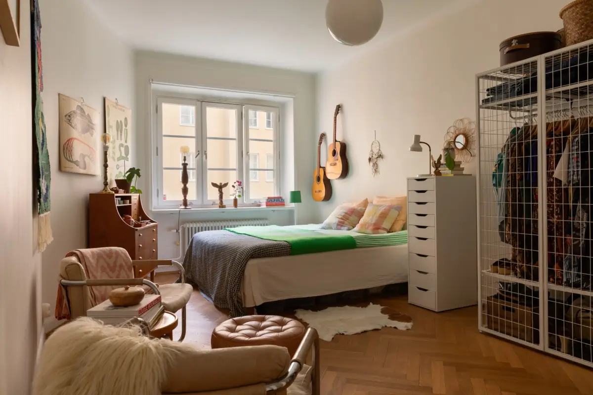 A Cozy 1920s Apartment Filled with Books, Art, and Music 18 master bedroom with open wardrobe
