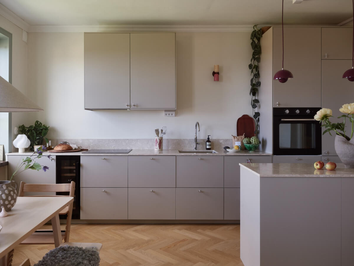 A Stockholm Apartment with a Butter-Yellow Bedroom 8 modern scandinavian kitchen gray cabinets