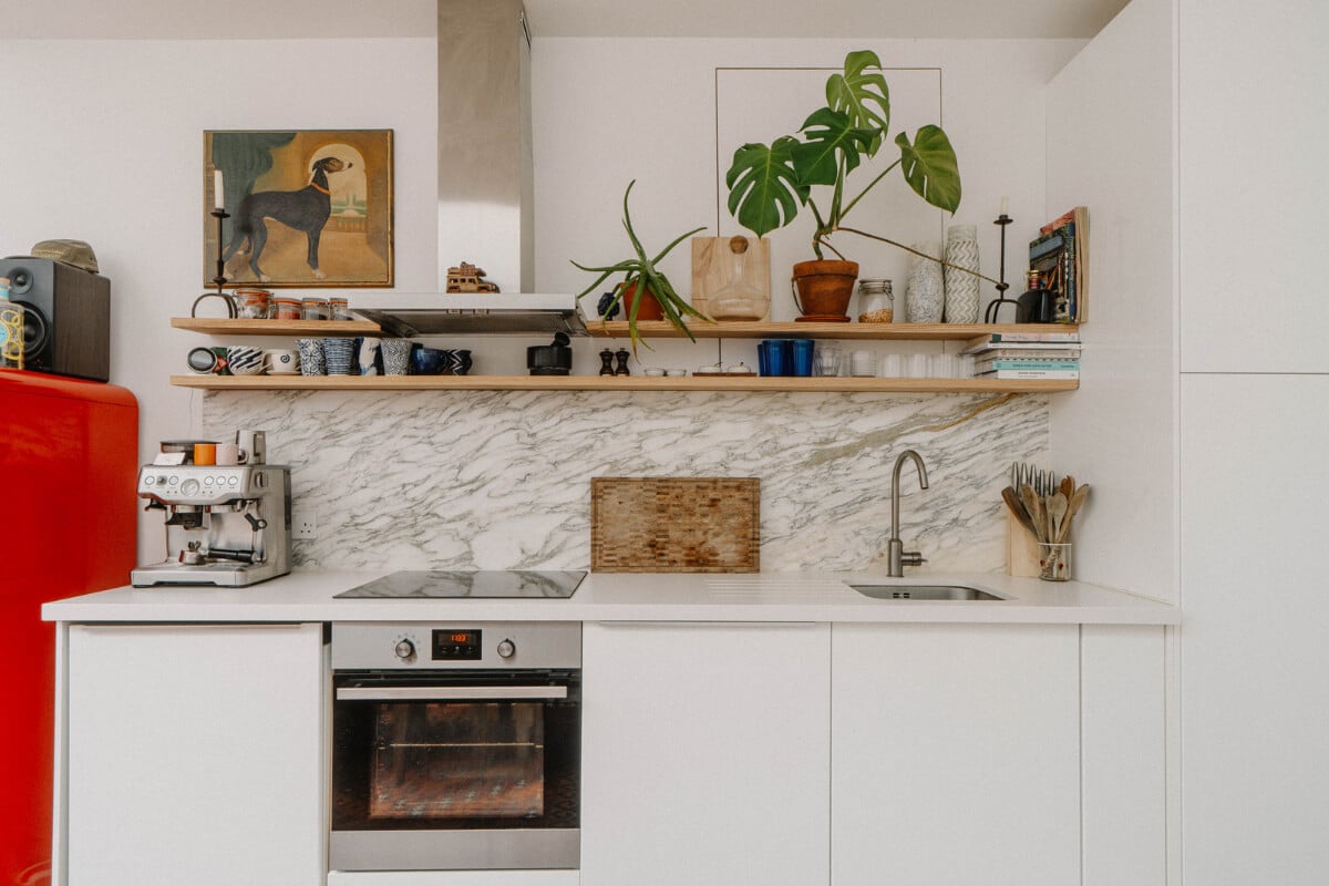 A Modern Ground-Floor Apartment with a Tiny Patio Garden 3 modern white kitchen cabinets wooden shelves