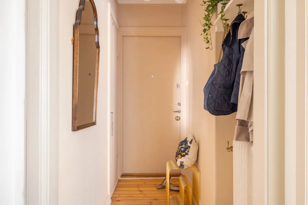 A Small Beige Stockholm Apartment with Plenty of Storage 22 narrow hall with coat rack A Small Beige Stockholm Apartment with Plenty of Storage