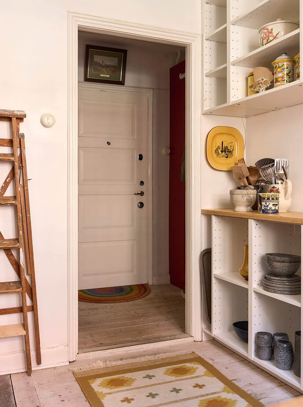 A Blue Living Room Filled with Art in a Swedish Apartment 18 open kitchen cabinets