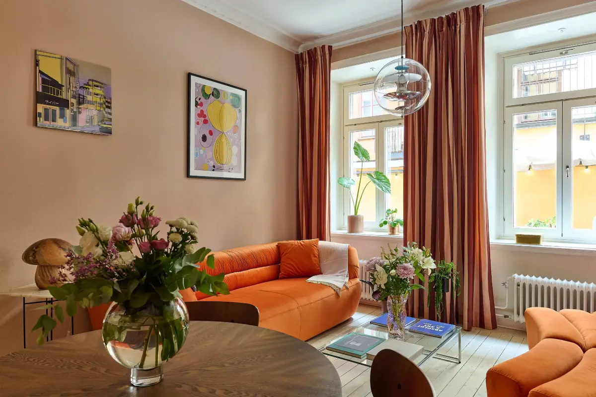 A Colorful Stockholm Apartment with a Large Terrace 2 orange and pink living room