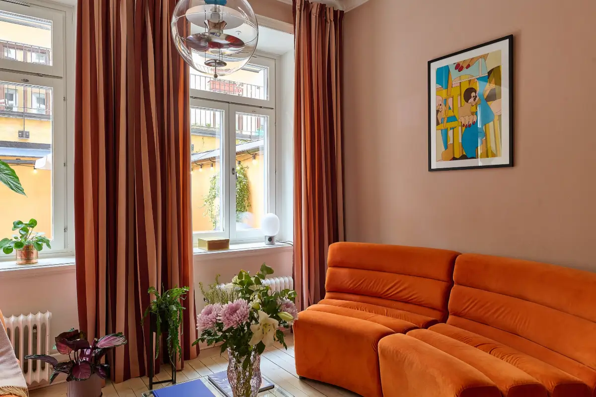 A Colorful Stockholm Apartment with a Large Terrace 5 orange sofa pink living room
