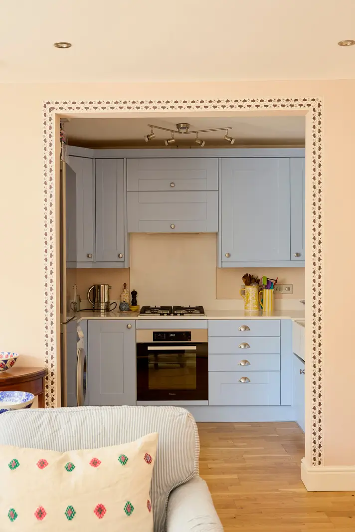 Pastel Hues in a Two-Bedroom Garden Apartment in West Kensington 7 pastel blue kitchen decorative doorway