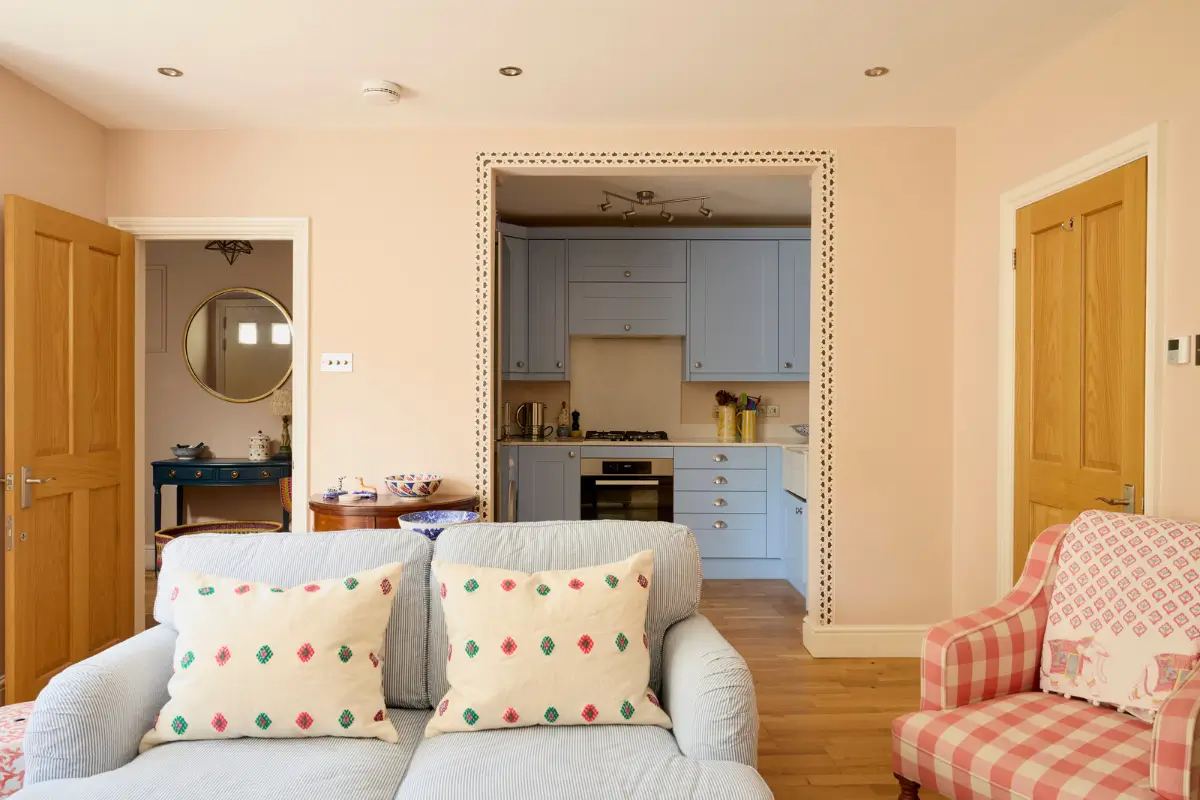 Pastel Hues in a Two-Bedroom Garden Apartment in West Kensington 6 pastel pink and blue living space with kitchen