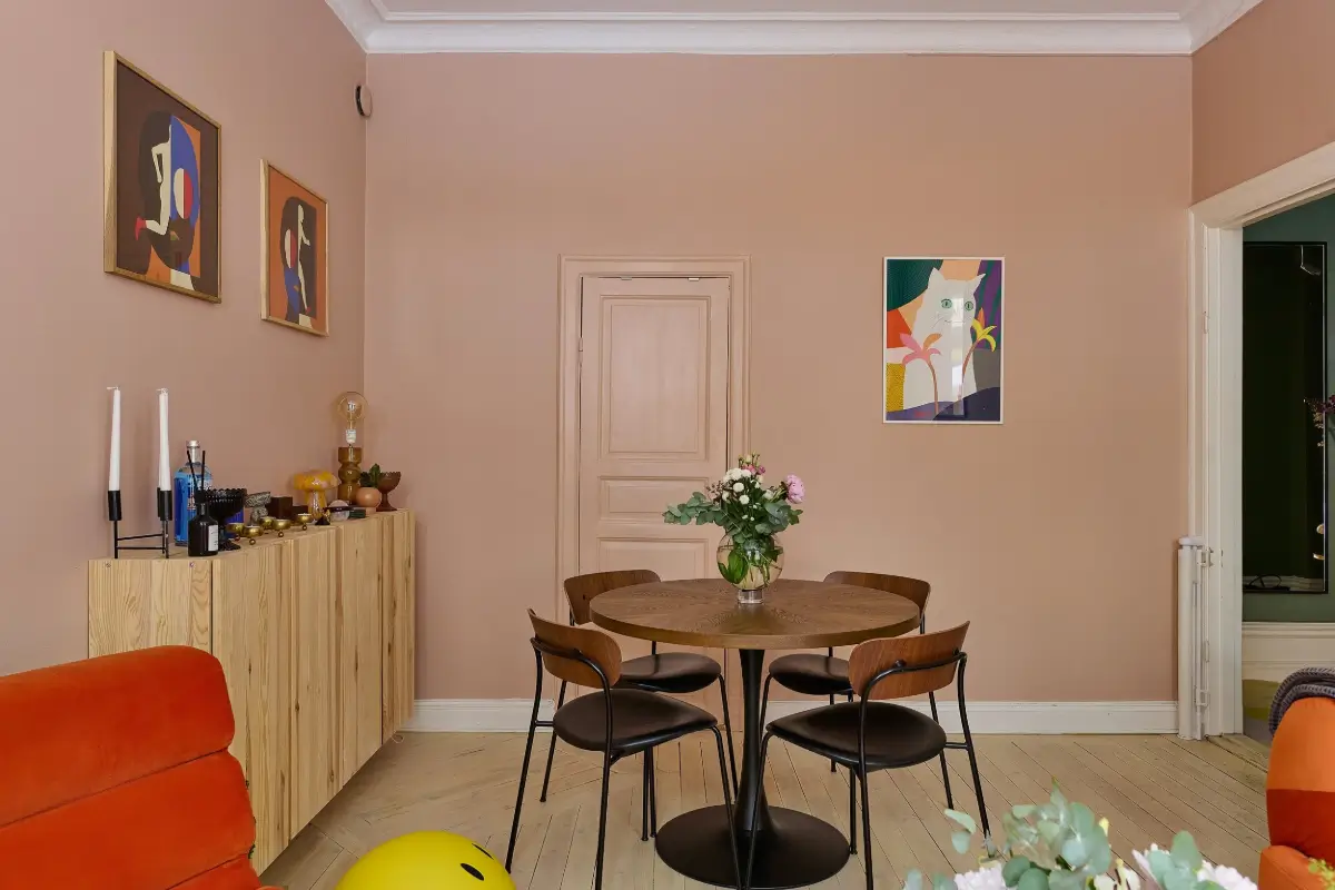 A Colorful Stockholm Apartment with a Large Terrace 6 pink living room with round dining table