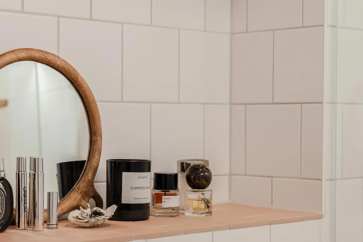 Colorful Rooms in a Practical Stockholm Family Apartment 21 pink tiled bathroom shelf