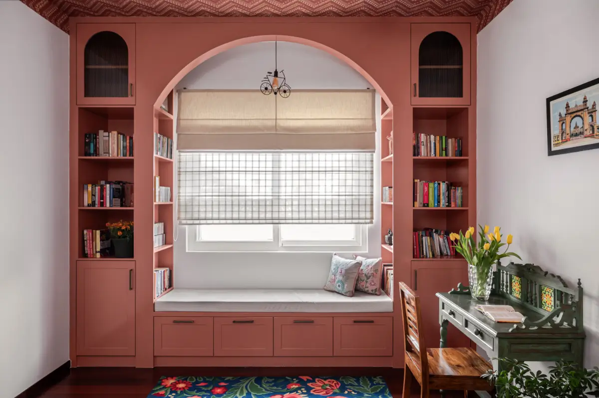 A South Indian Family Home Where Heritage Meets Bold Color Choices 19 pink window seat built-in bookshelves nordroom