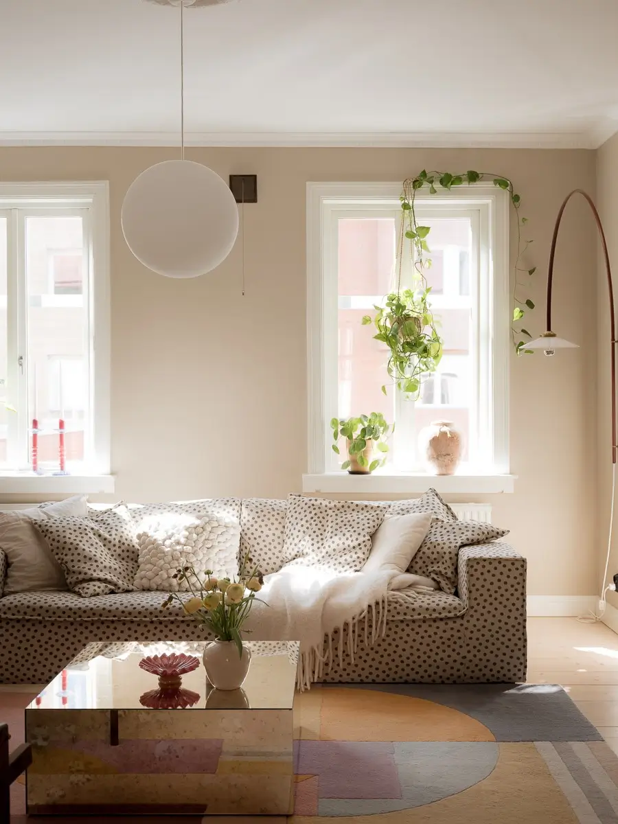 Neutral Shades and Period Elements in a Scandi Apartment 2 polkadot sofa mirror coffee table pastel rug