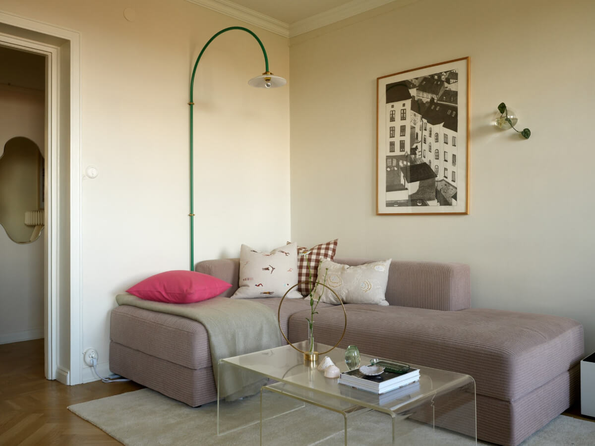 A Stockholm Apartment with a Butter-Yellow Bedroom 2 ribbed sofa and green wall lamp
