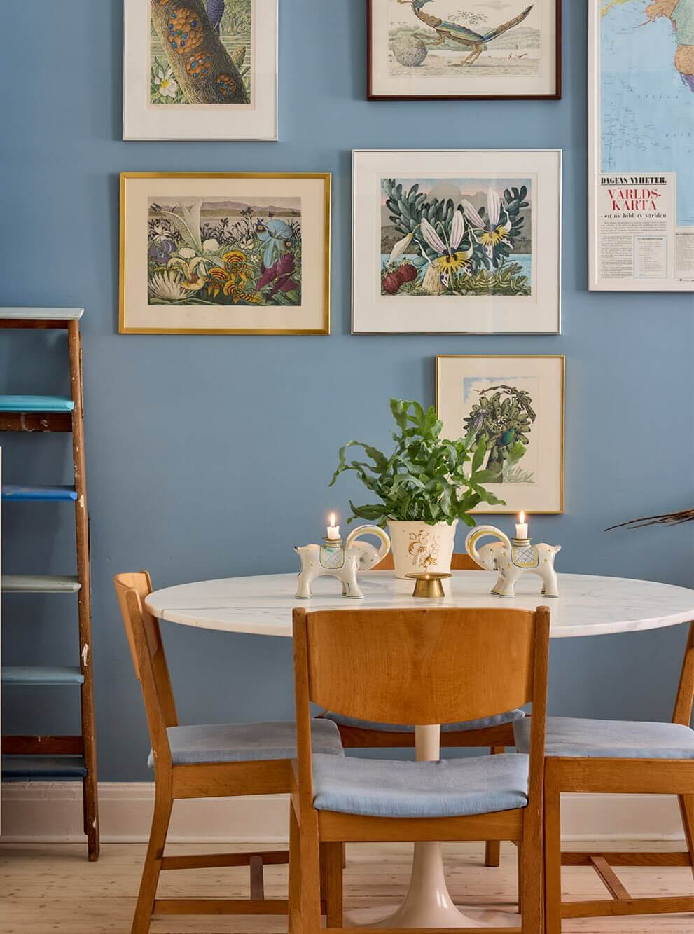 A Blue Living Room Filled with Art in a Swedish Apartment 8 round dining table blue sitting room
