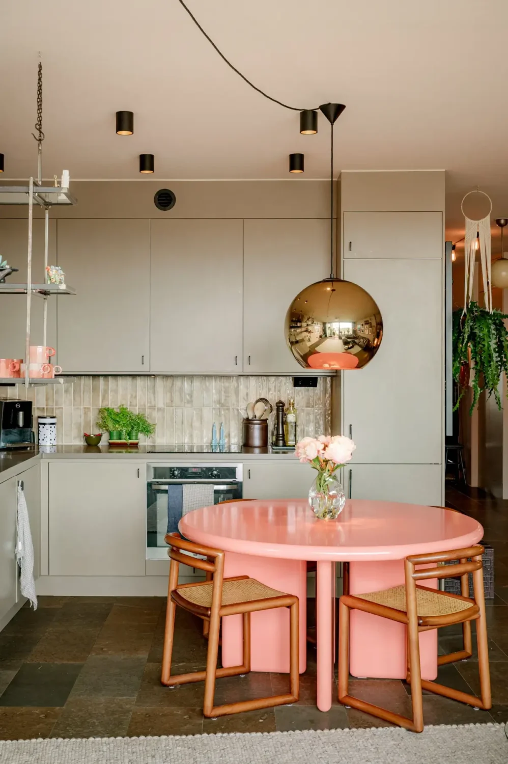 A Modern Swedish Apartment with Half-Painted Pink Walls 8 round pink dining table