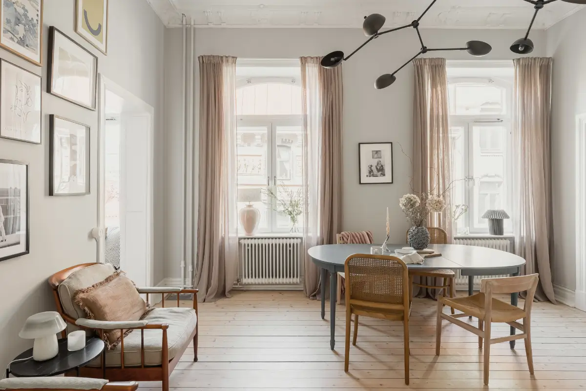 A Gray Scandinavian Apartment with a Royal History 3 scandi living room large windows wooden floor blue dining table