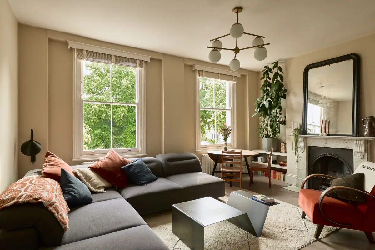 A Classic Victorian Duplex with a Lush, Private Garden in London 3 serene living room large windows marble fireplace