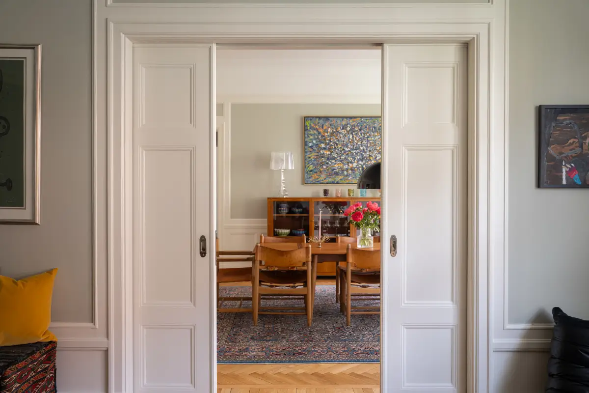 A Classic Stockholm Apartment with a Sky-Blue Kitchen 4 sliding doors dining room