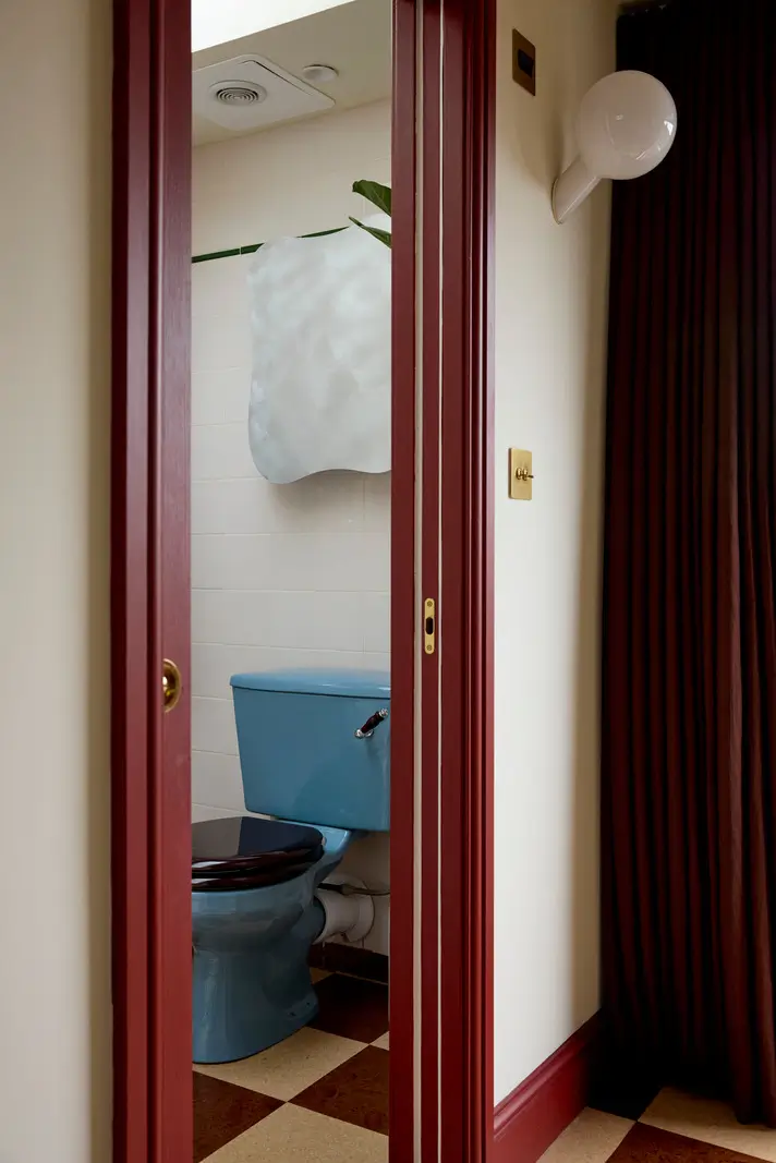 A Victorian Home with a Rich Color Palette and a Lush Garden 22 small bathroom checkerboard floor blue toilet