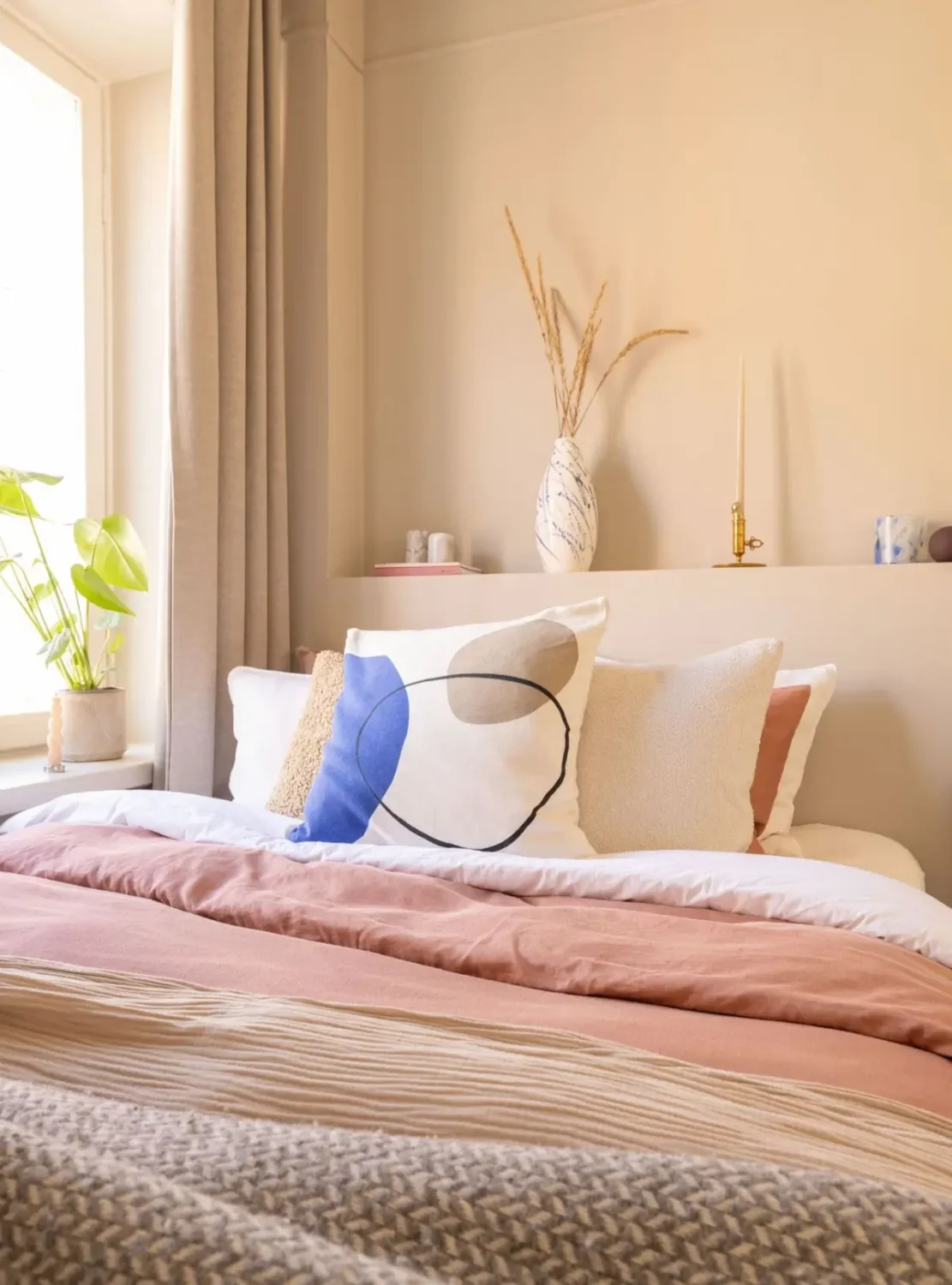 A Small Beige Stockholm Apartment with Plenty of Storage 19 small beige bedroom headboard ledge pink bedding nordroom