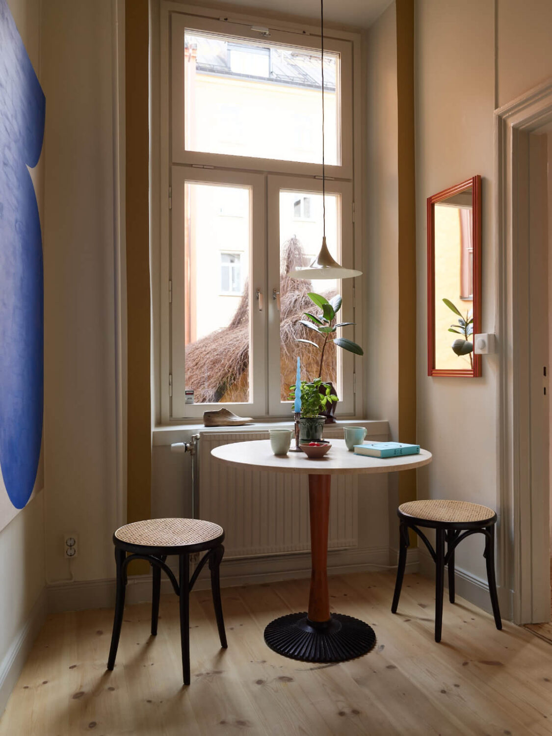 Blue and Red Color Accents in a Stylish Scandinavian Apartment 27 small kitchen table under window