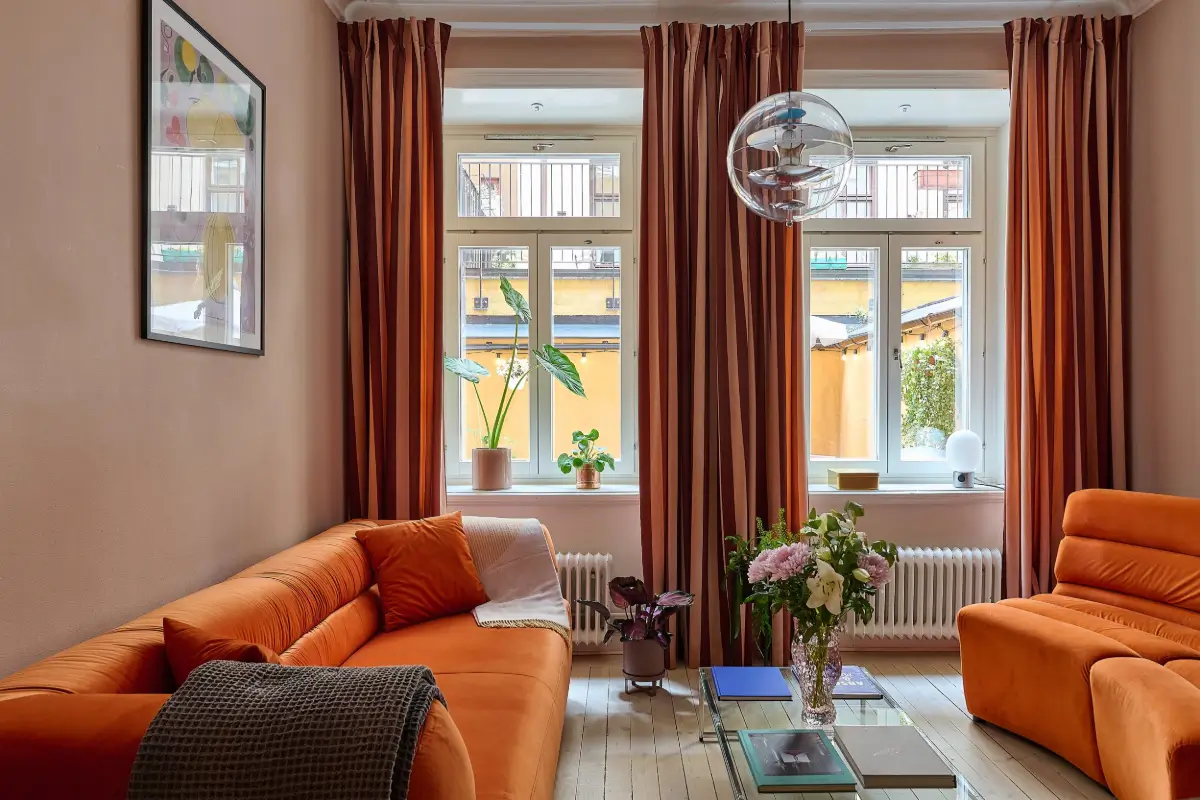 A Colorful Stockholm Apartment with a Large Terrace 3 small orange and pink living room wooden floor