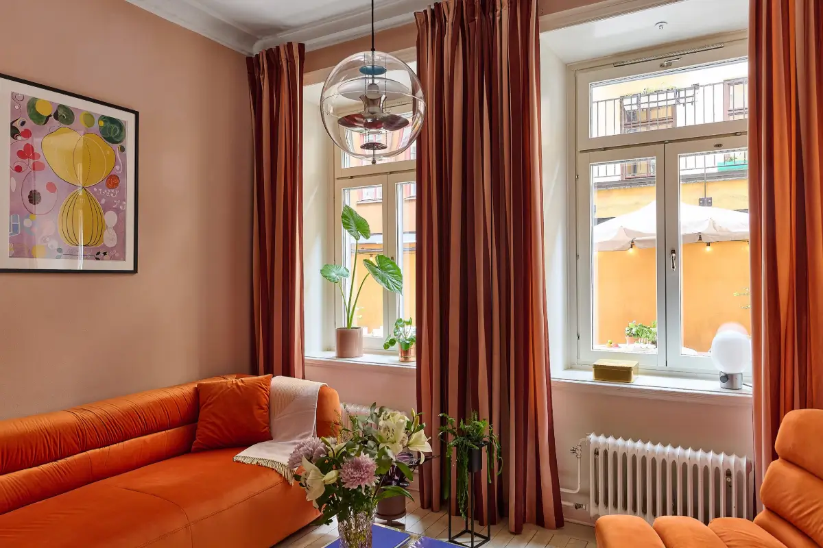 A Colorful Stockholm Apartment with a Large Terrace 4 small pink living room orange sofas