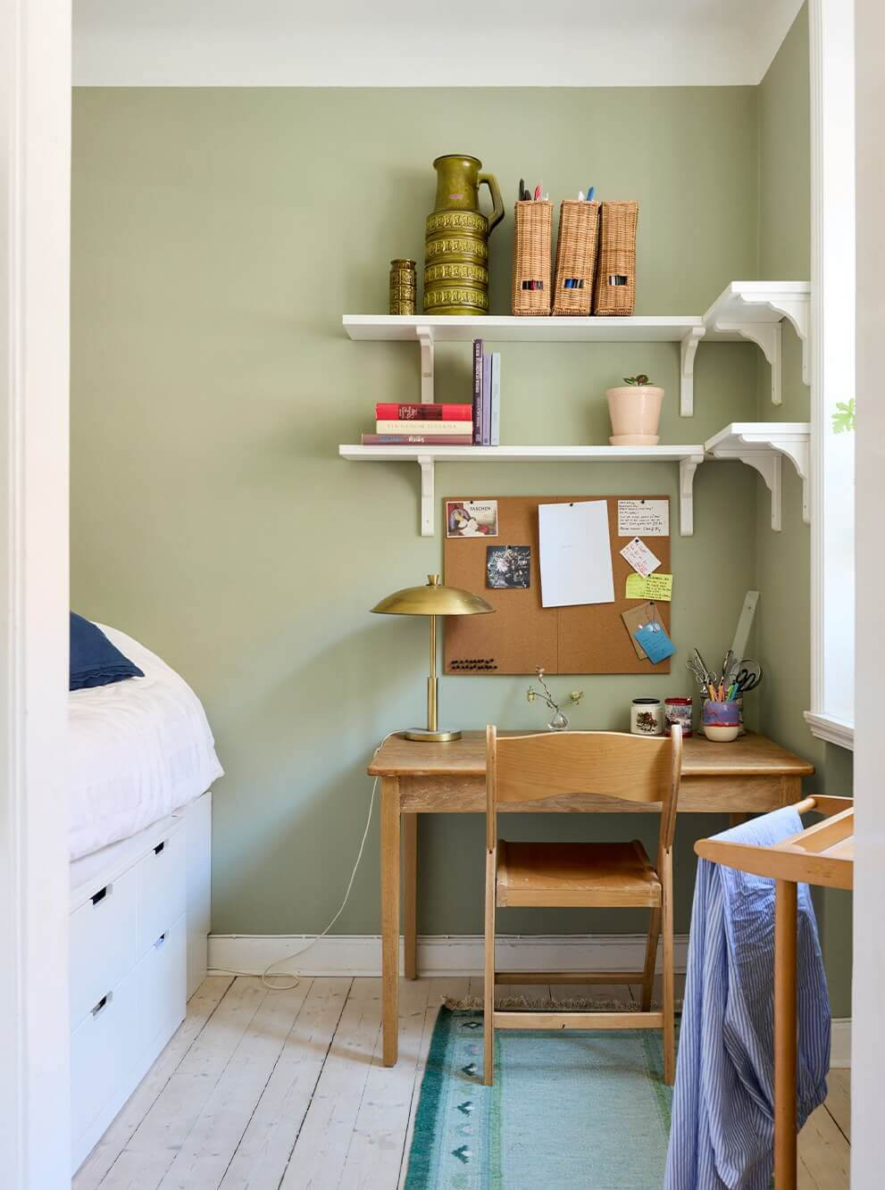 A Blue Living Room Filled with Art in a Swedish Apartment 16 small sage green bedroom with desk and raised bed with drawers