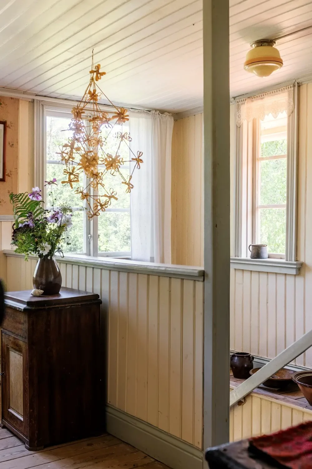 A Historic Lakeside Summer House in the Stockholm Archipelago 22 staircase yellow paneling