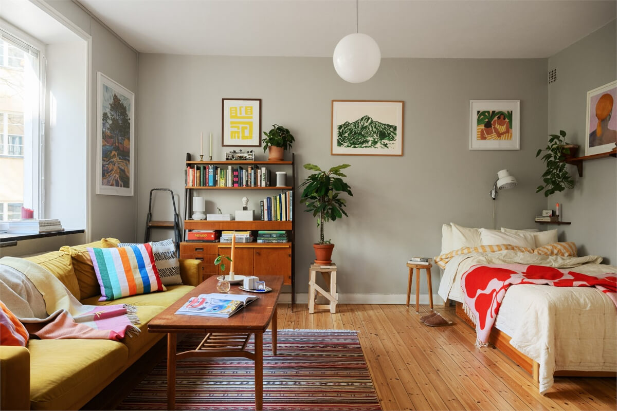 studio apartment gray walls midcentury furniture ochre sofa