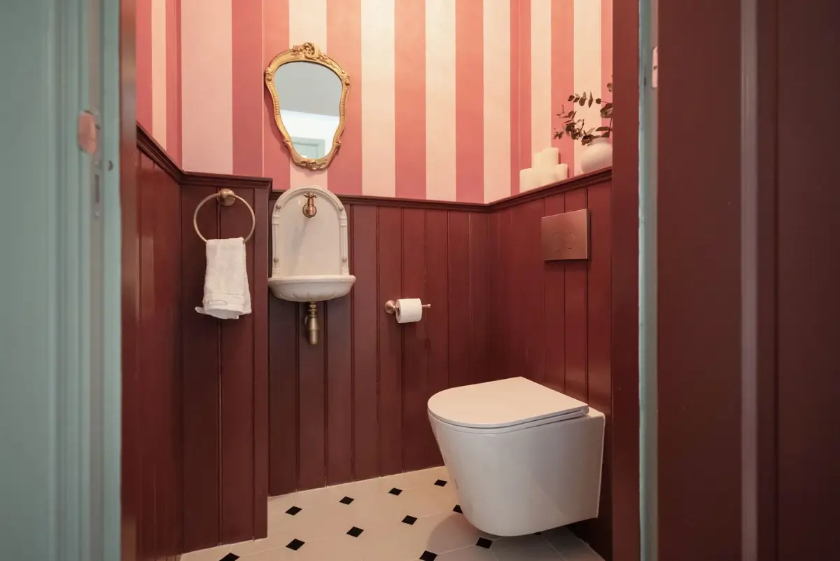 Art Nouveau Elegance Meets Modern Living in a Pink & Green Apartment 24 toilet pink striped and deep pink paneling Art Nouveau Elegance Meets Modern Living in a Pink & Green Apartment
