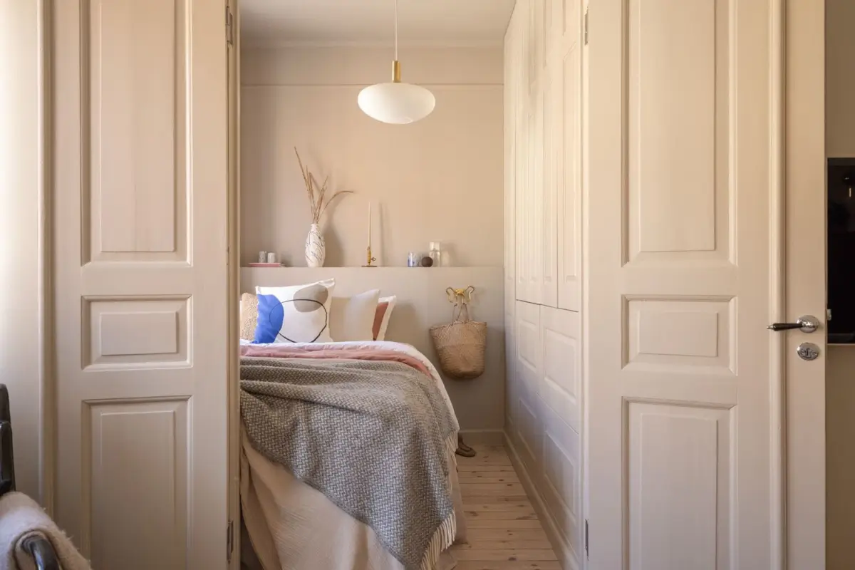 A Small Beige Stockholm Apartment with Plenty of Storage 16 view into bedroom