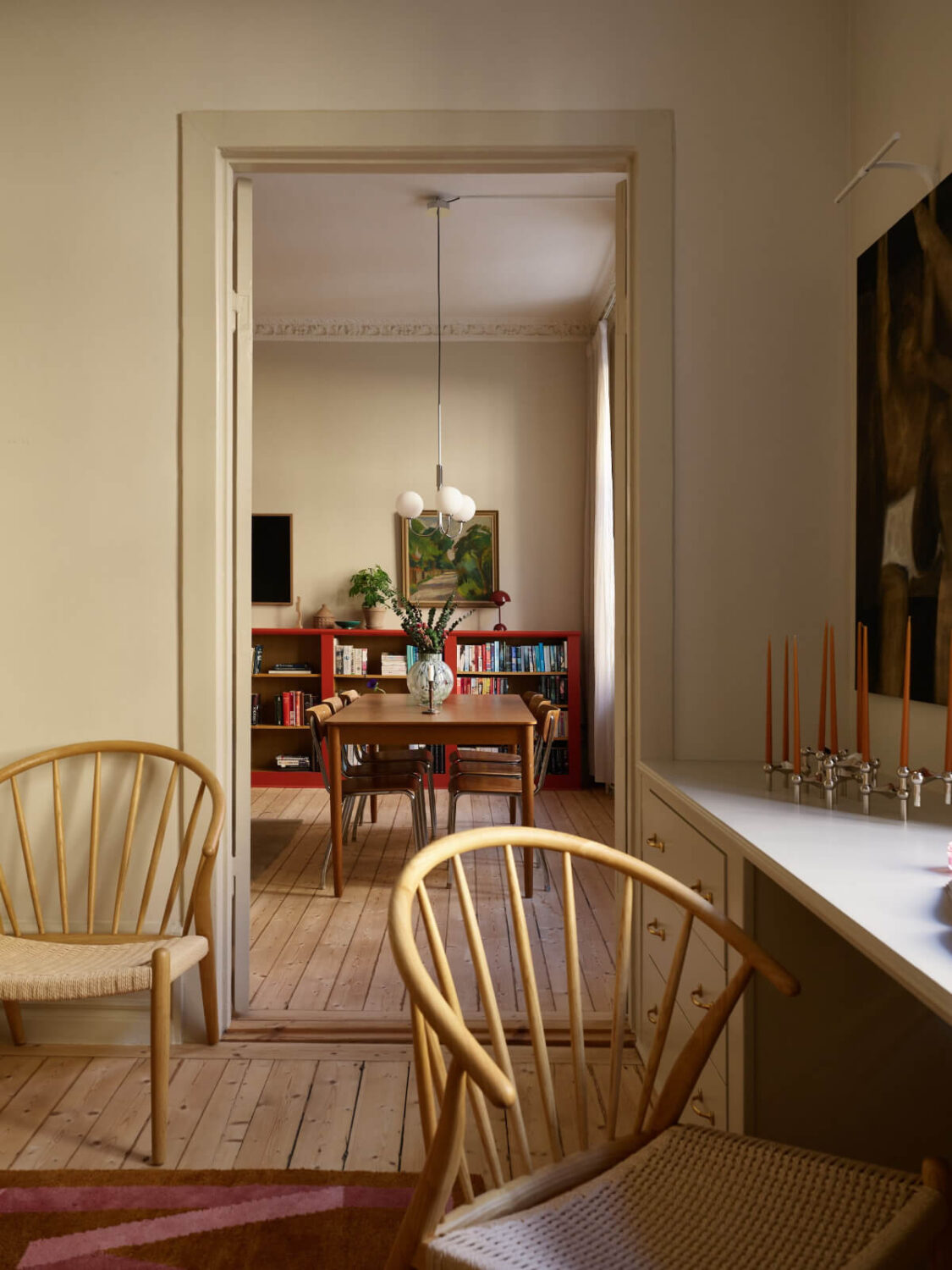Blue and Red Color Accents in a Stylish Scandinavian Apartment 16 view into living room