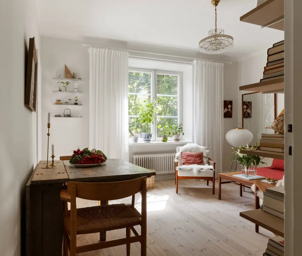 A Red Kitchen in a Small and Light Scandinavian Apartment 5 view into living room rustic wooden folding table