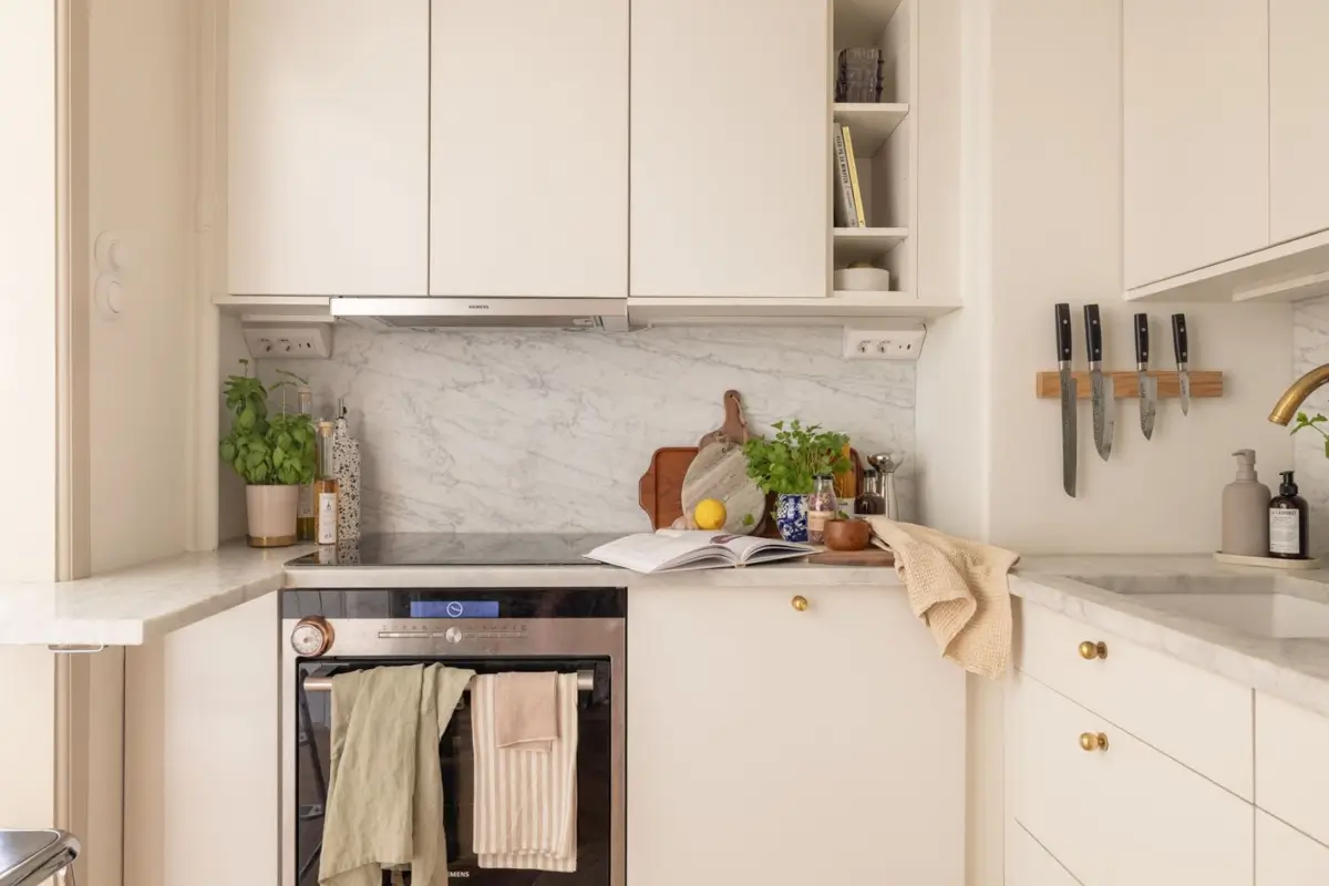 A Small Beige Stockholm Apartment with Plenty of Storage 13 white kitchen marble countertop