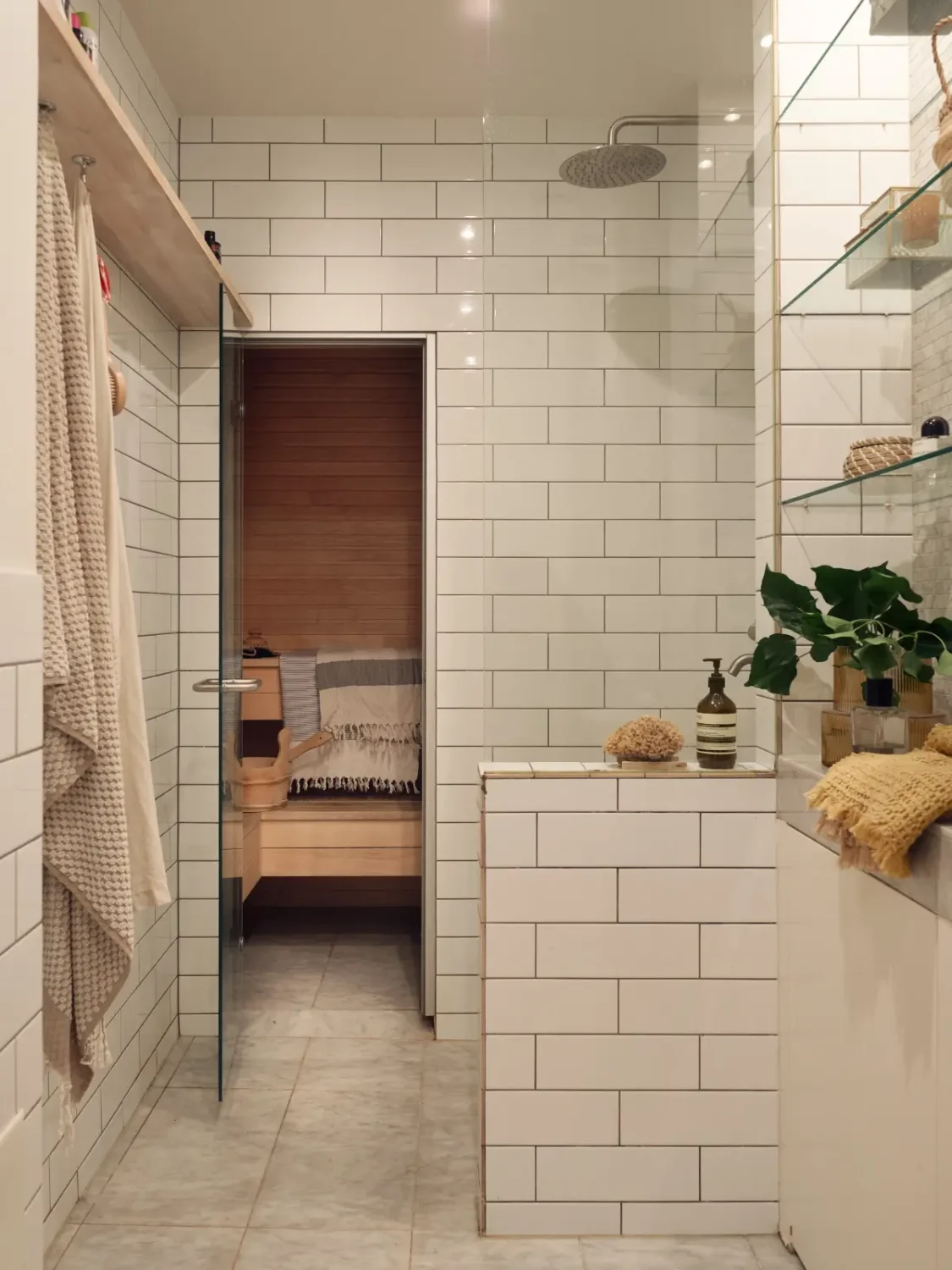 Industrial Elements in a 1960s Duplex Apartment in Stockholm 18 white tiled bathroom with sauna