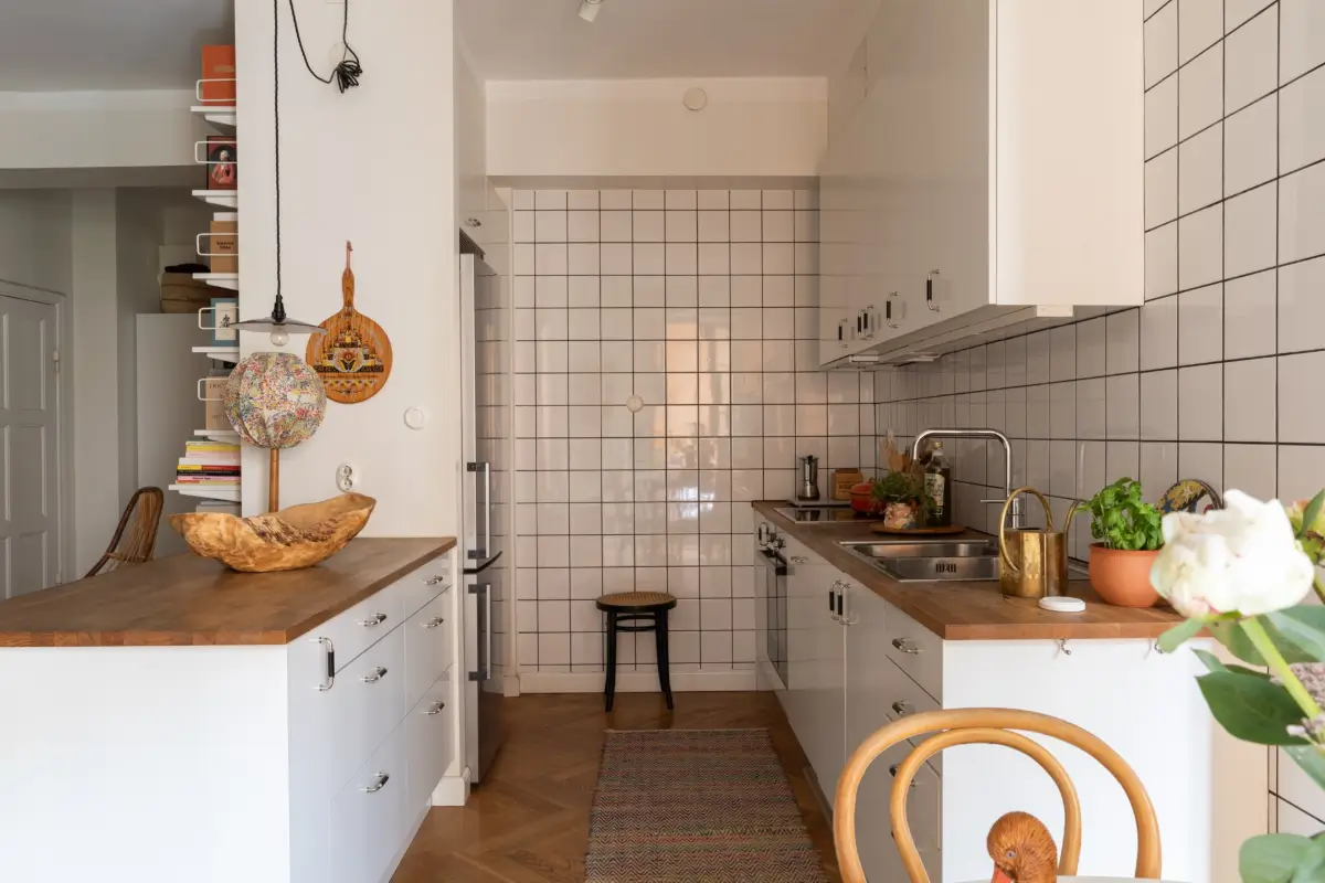 A Cozy 1920s Apartment Filled with Books, Art, and Music 10 white tiled kitchen