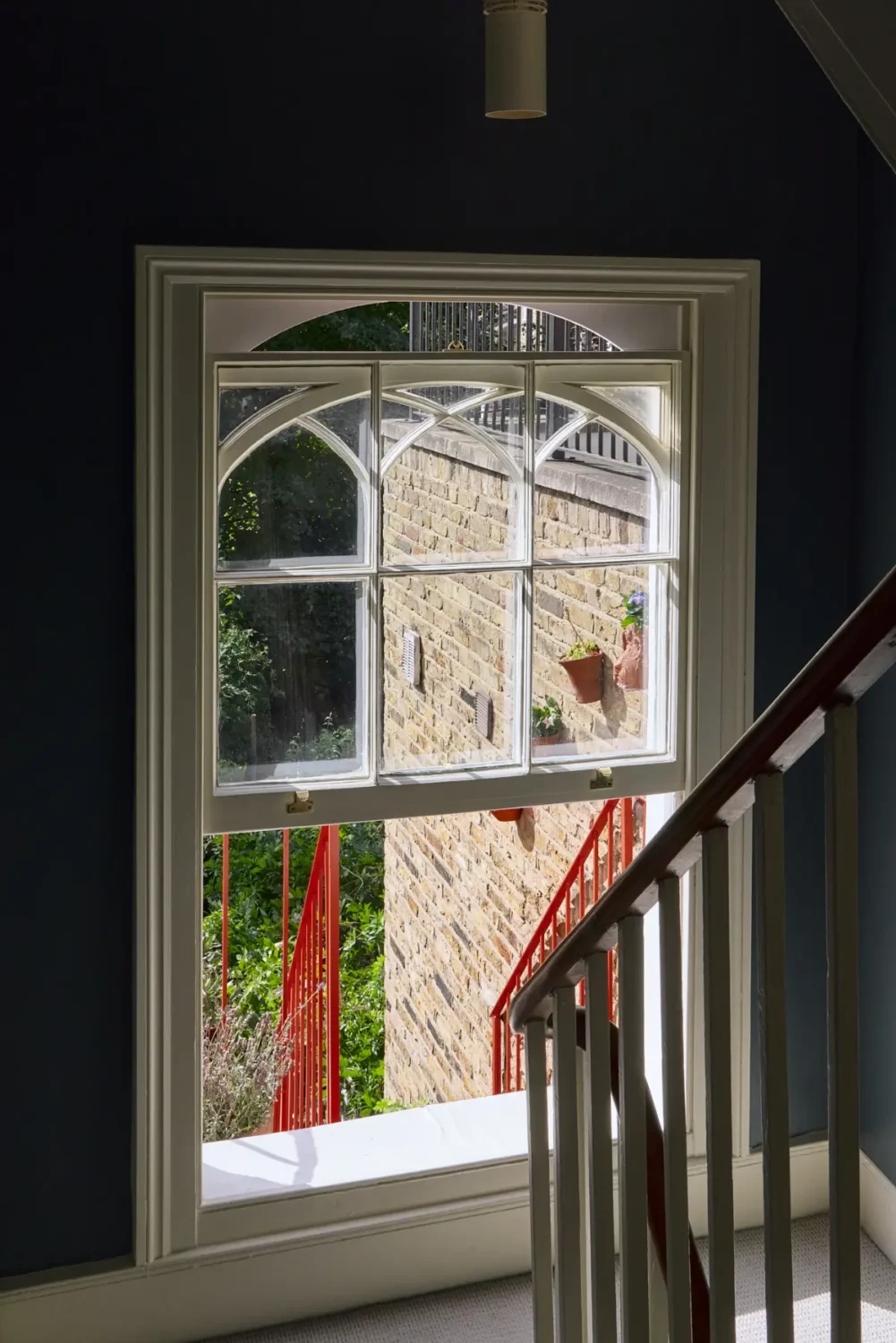 A Classic Victorian Duplex with a Lush, Private Garden in London 30 window garden access red stairs