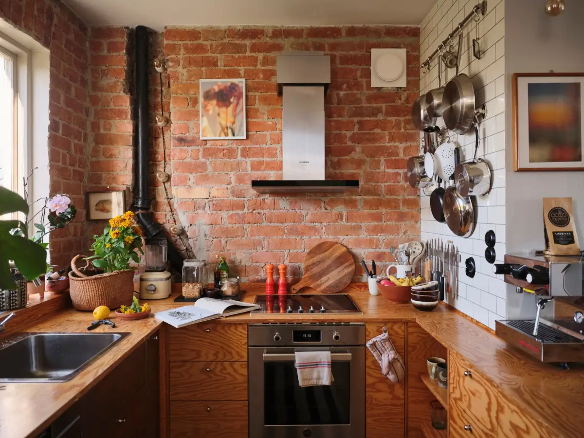 A Pink Bathroom and a Plywood Kitchen in a Stockholm Apartment 4 wood kitchen exposed brick wall