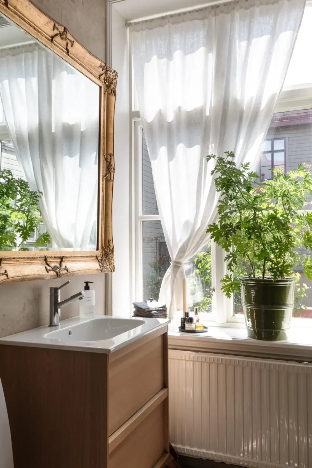 A Dark Gray Swedish Apartment with an Olive Green Kitchen 22 wooden bathroom vanity gilded mirror