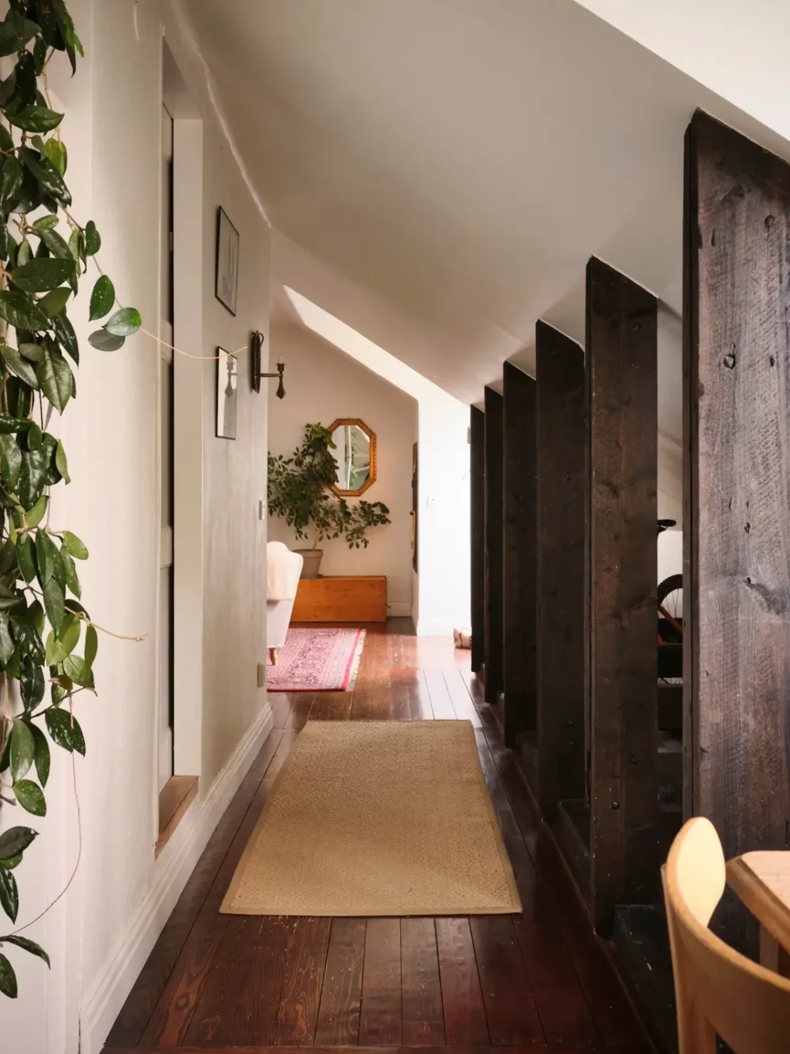 Exposed Beams and Dark-Stained Floorboards in a Cozy Attic Apartment 8 attic apartment hall