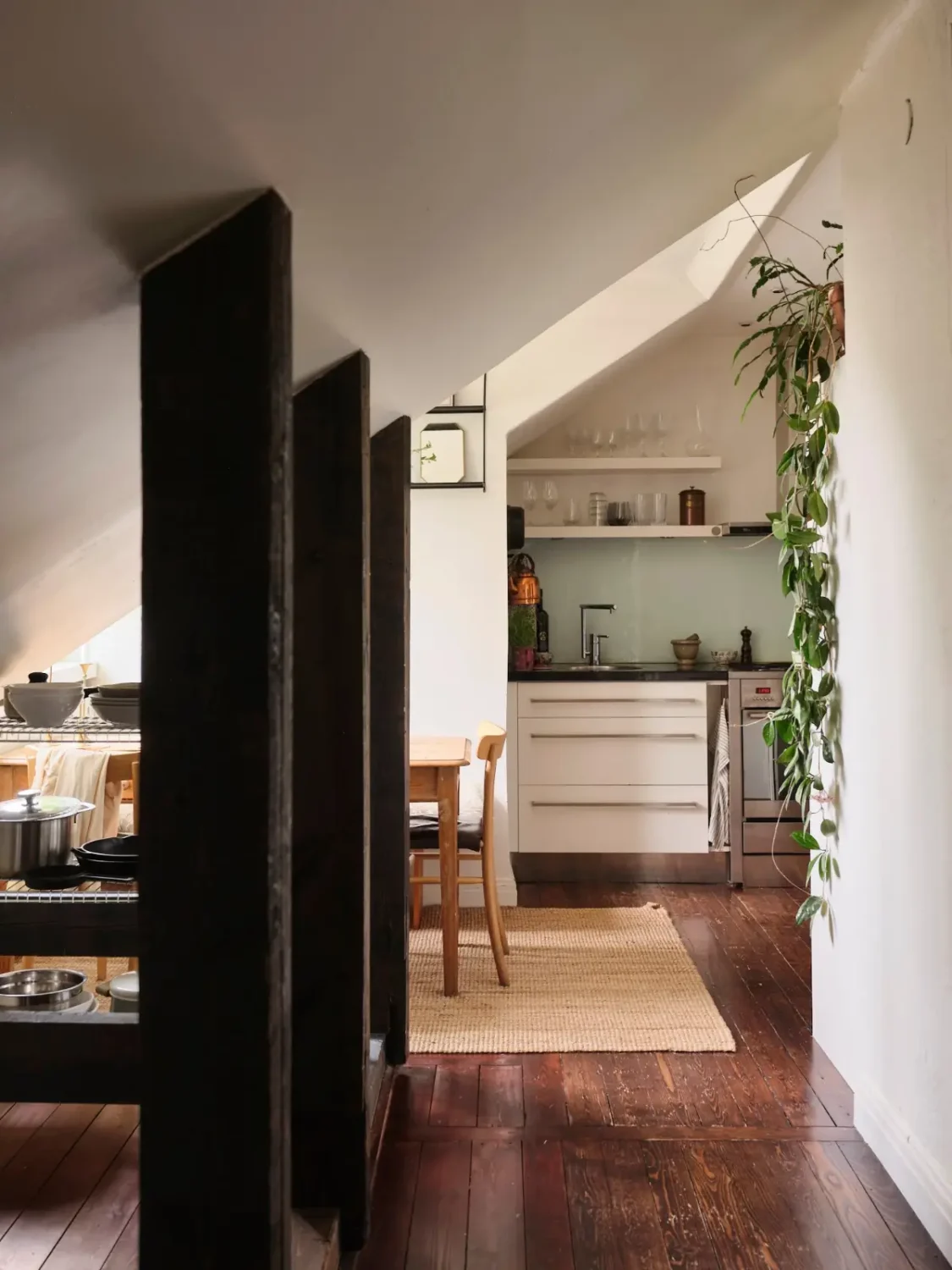 Exposed Beams and Dark-Stained Floorboards in a Cozy Attic Apartment 10 attic apartment kitchen wooden beams