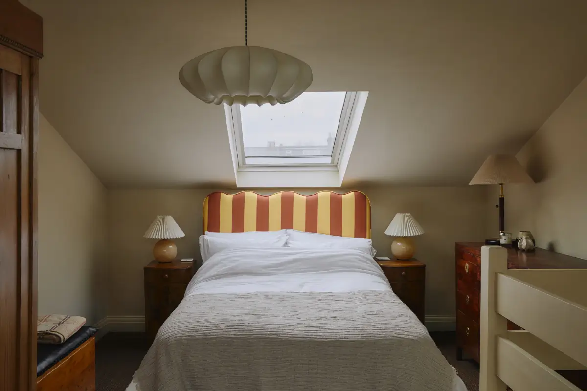 Modern Craftsmanship and Historic Charm in a London Home 27 attic bedroom striped headboard