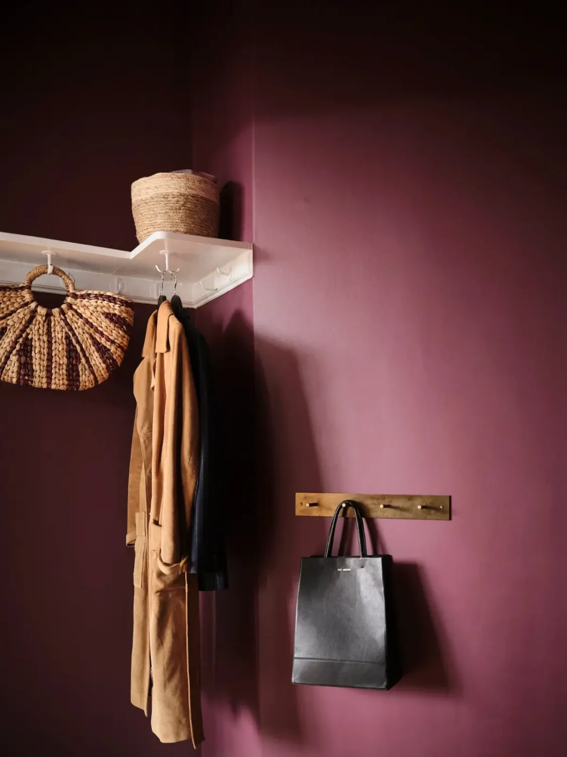 Warm Pink Walls and a Glass Room Divider in a Small Stockholm Apartment 28 aubergine colored wall hat shelf