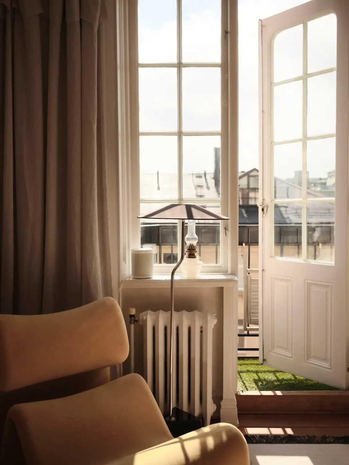Warm Pink Walls and a Glass Room Divider in a Small Stockholm Apartment 14 balcony door