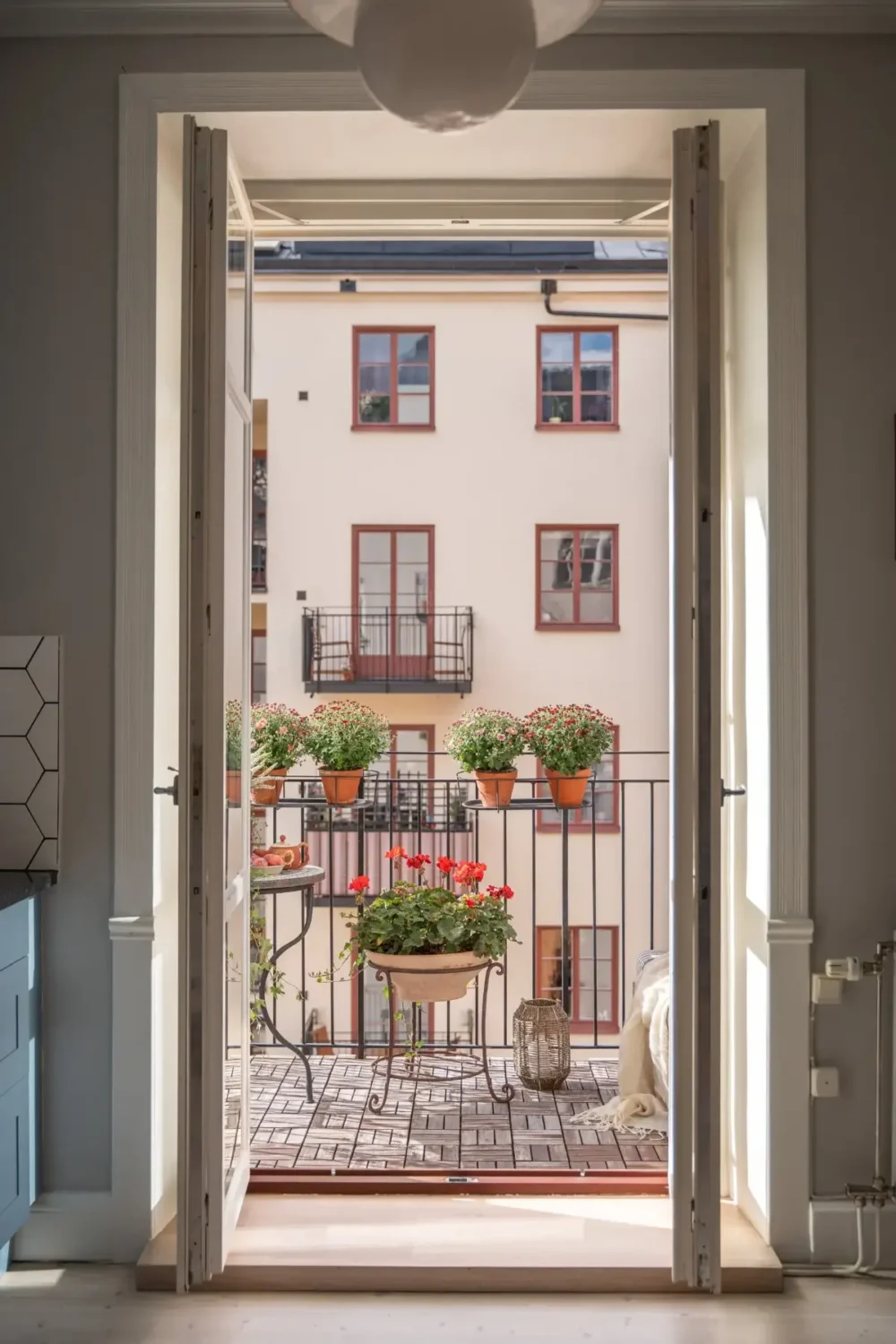 A Light Turn-of-the-Century Apartment with a Blue Kitchen 14 balcony doors