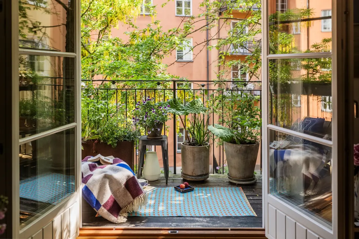 A Charming Swedish Courtyard Apartment Filled with Art 4 balcony with blue rug