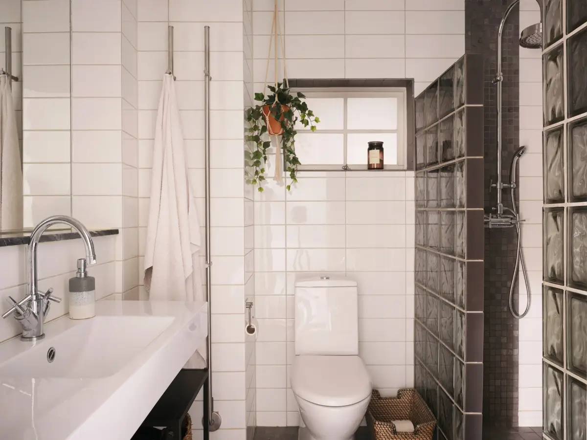 Exposed Beams and Dark-Stained Floorboards in a Cozy Attic Apartment 16 bathroom
