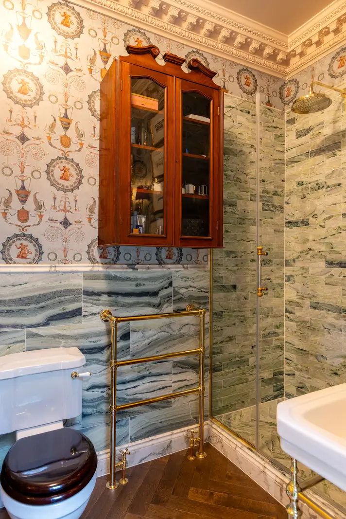 A Mixture of Patterns, Colors, and Materials in a Stunning London Apartment 23 bathroom green marble tiles iksel wallpaper